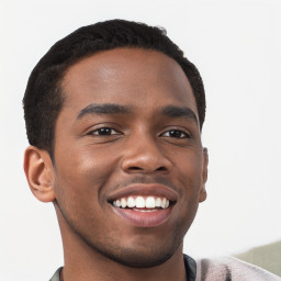 Joyful black young-adult male with short  brown hair and brown eyes