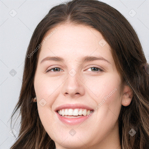 Joyful white young-adult female with long  brown hair and grey eyes