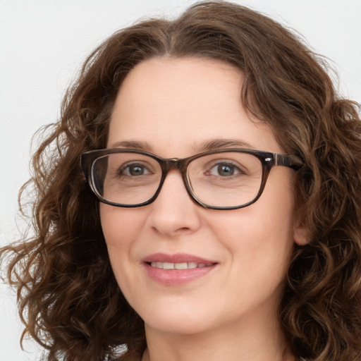 Joyful white young-adult female with medium  brown hair and green eyes