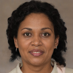 Joyful black adult female with medium  brown hair and brown eyes