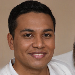 Joyful black young-adult male with short  brown hair and brown eyes