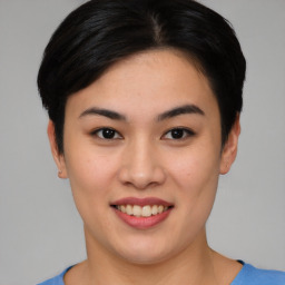 Joyful asian young-adult female with short  black hair and brown eyes