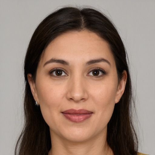 Joyful white young-adult female with long  brown hair and brown eyes