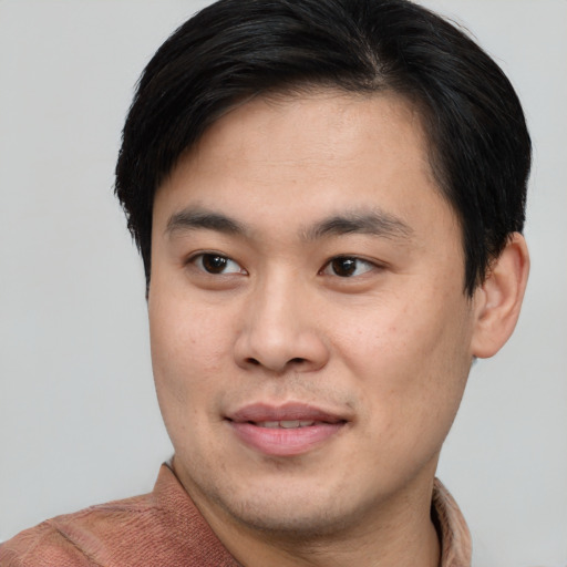 Joyful asian young-adult male with short  brown hair and brown eyes