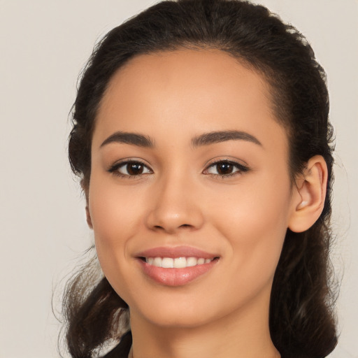 Joyful latino young-adult female with medium  brown hair and brown eyes