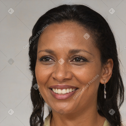 Joyful latino adult female with long  brown hair and brown eyes