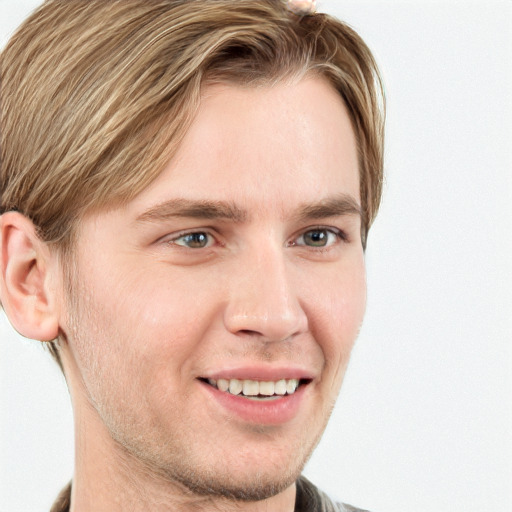 Joyful white young-adult male with short  brown hair and blue eyes