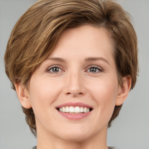 Joyful white young-adult female with medium  brown hair and green eyes