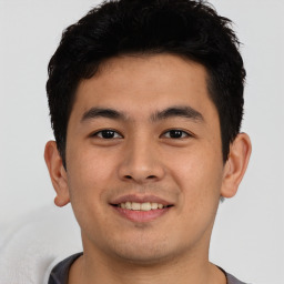 Joyful asian young-adult male with short  black hair and brown eyes