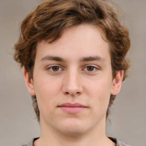 Joyful white young-adult male with medium  brown hair and grey eyes