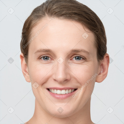 Joyful white young-adult female with short  brown hair and grey eyes