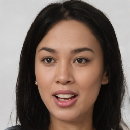 Joyful asian young-adult female with long  brown hair and brown eyes