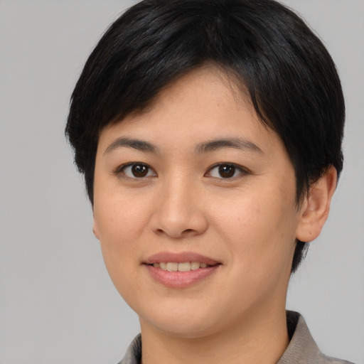 Joyful asian young-adult female with short  brown hair and brown eyes