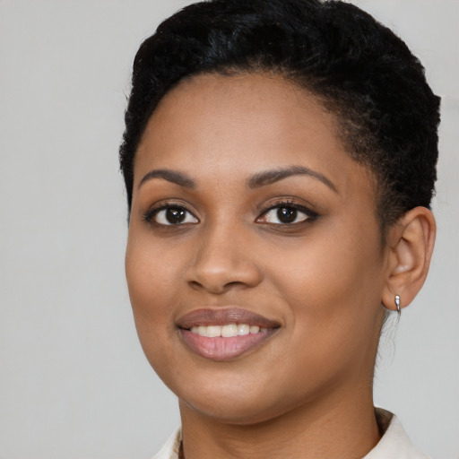 Joyful latino young-adult female with short  black hair and brown eyes