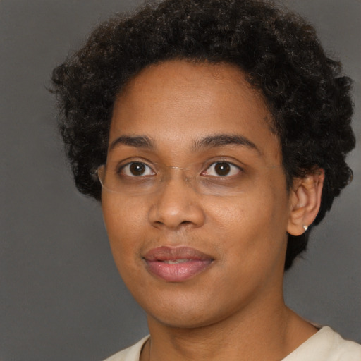 Joyful black young-adult female with short  brown hair and brown eyes