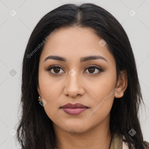 Joyful latino young-adult female with long  brown hair and brown eyes