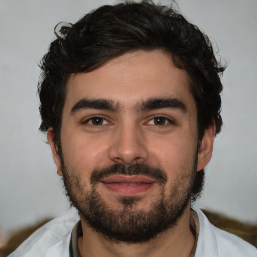 Joyful white young-adult male with short  black hair and brown eyes