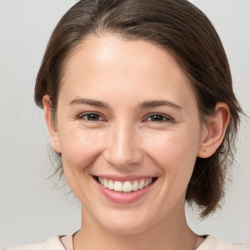 Joyful white young-adult female with medium  brown hair and brown eyes