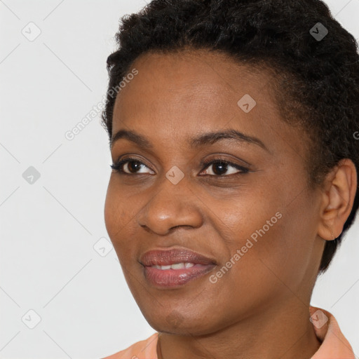 Joyful black young-adult female with short  brown hair and brown eyes