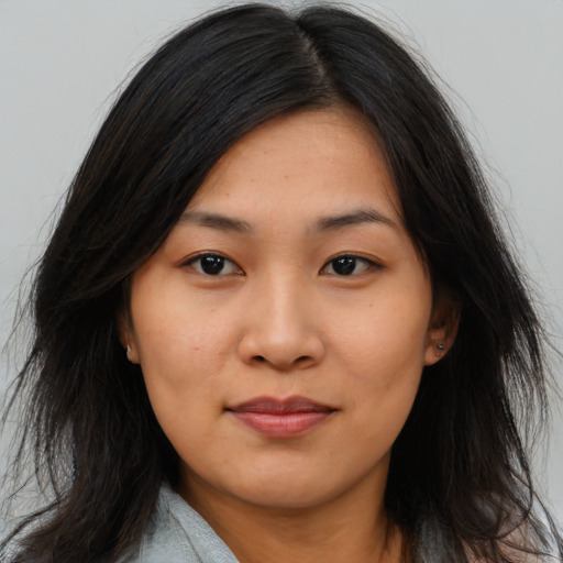 Joyful asian young-adult female with long  brown hair and brown eyes