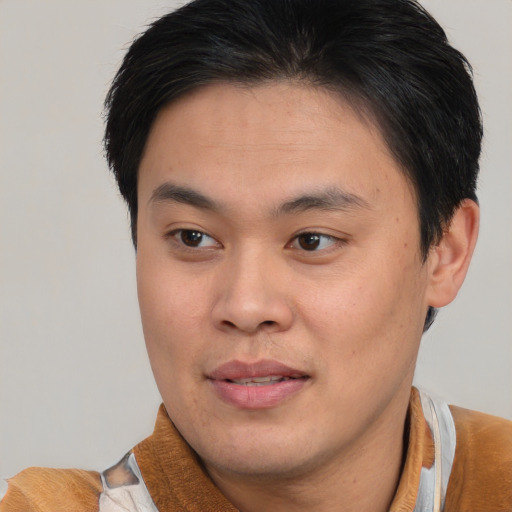 Joyful asian young-adult male with short  brown hair and brown eyes