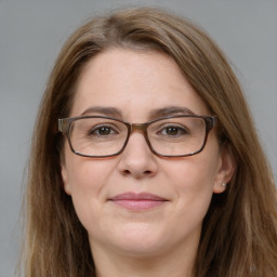 Joyful white adult female with long  brown hair and brown eyes