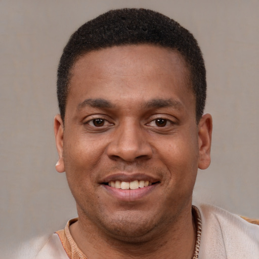Joyful latino young-adult male with short  brown hair and brown eyes