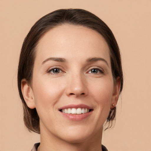 Joyful white young-adult female with medium  brown hair and brown eyes