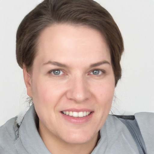 Joyful white adult female with medium  brown hair and grey eyes