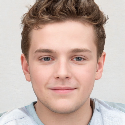 Joyful white child male with short  brown hair and blue eyes