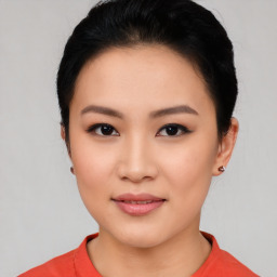 Joyful asian young-adult female with short  black hair and brown eyes