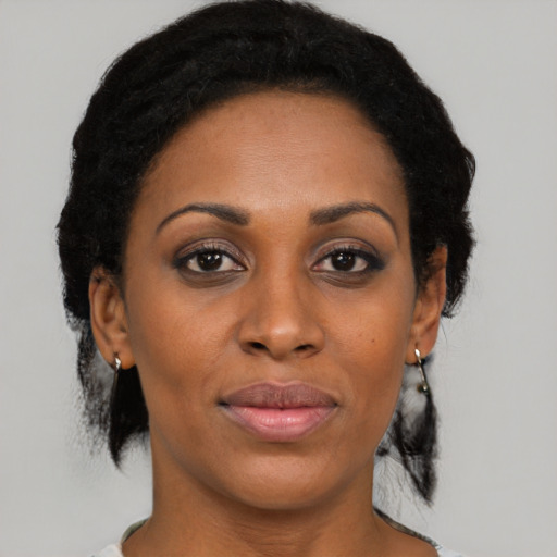 Joyful black adult female with medium  black hair and brown eyes
