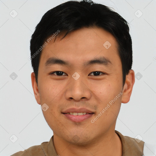 Joyful asian young-adult male with short  black hair and brown eyes