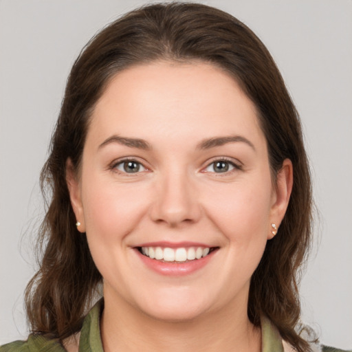 Joyful white young-adult female with medium  brown hair and grey eyes