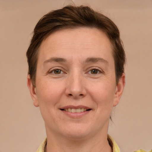 Joyful white adult female with short  brown hair and grey eyes