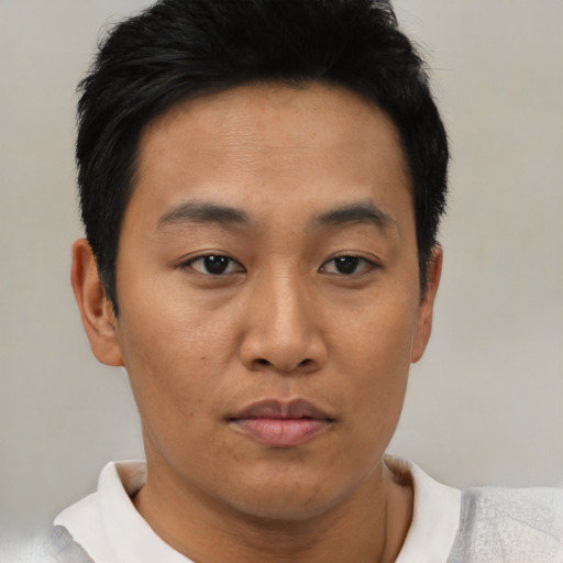 Joyful black young-adult male with short  brown hair and brown eyes