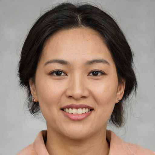 Joyful asian young-adult female with medium  brown hair and brown eyes