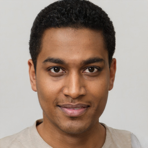 Joyful black young-adult male with short  black hair and brown eyes