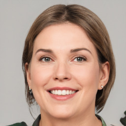 Joyful white young-adult female with medium  brown hair and green eyes