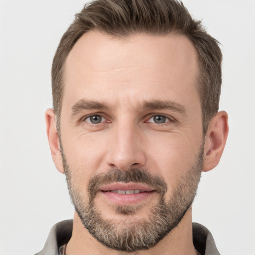 Joyful white adult male with short  brown hair and brown eyes