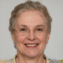 Joyful white middle-aged female with short  brown hair and blue eyes