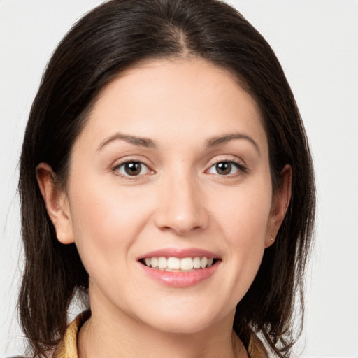 Joyful white young-adult female with medium  brown hair and brown eyes