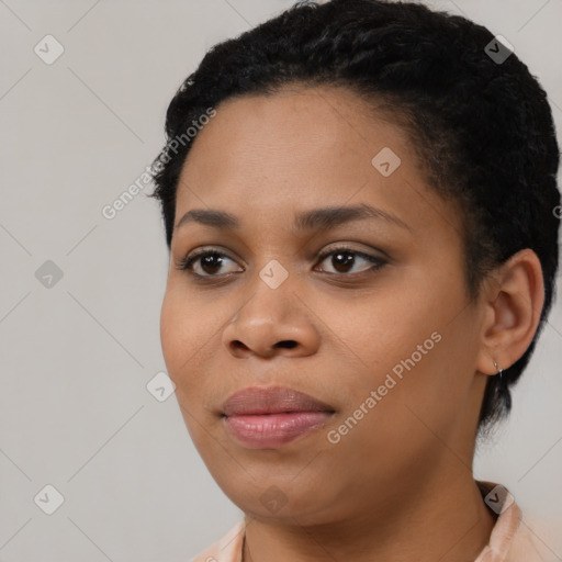 Joyful black young-adult female with short  black hair and brown eyes