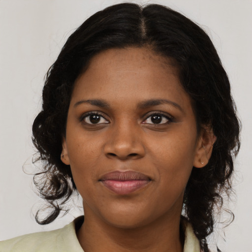 Joyful black young-adult female with medium  brown hair and brown eyes