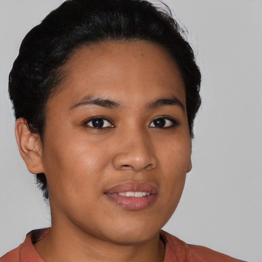 Joyful latino young-adult female with medium  black hair and brown eyes