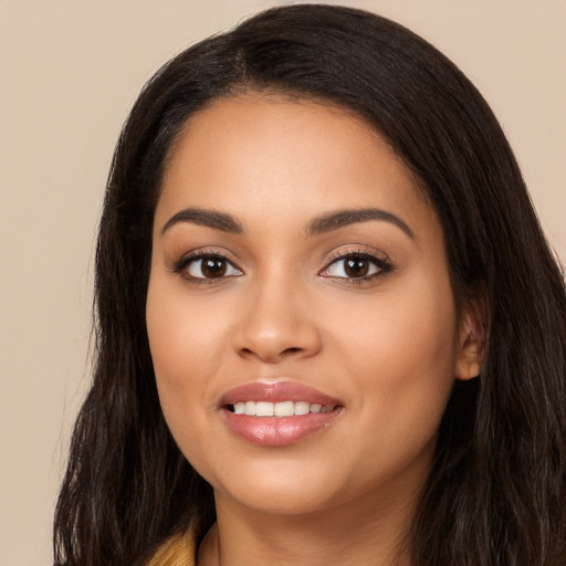 Joyful latino young-adult female with long  black hair and brown eyes