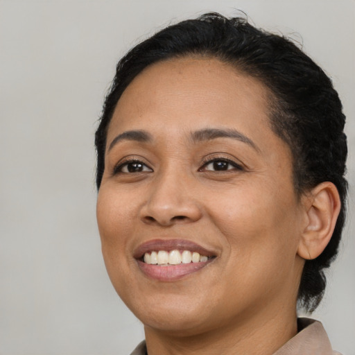 Joyful latino young-adult female with medium  black hair and brown eyes
