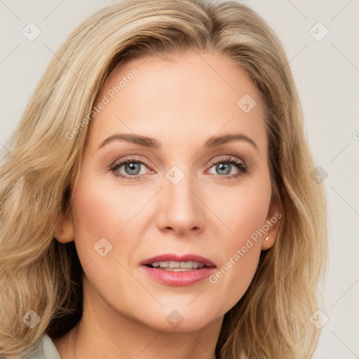 Joyful white young-adult female with long  brown hair and blue eyes