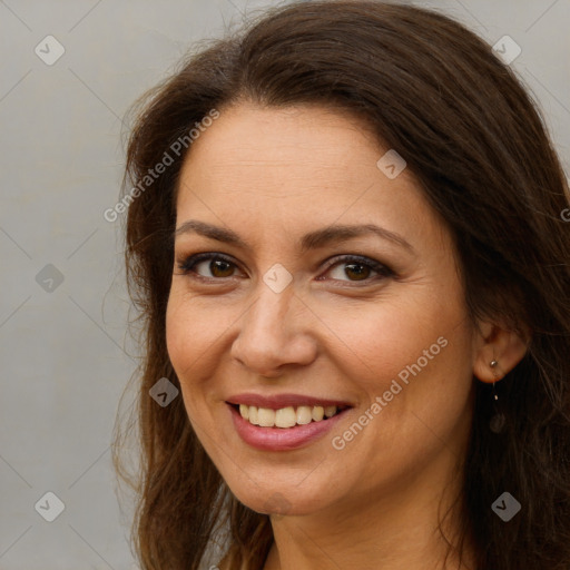 Joyful white adult female with long  brown hair and brown eyes