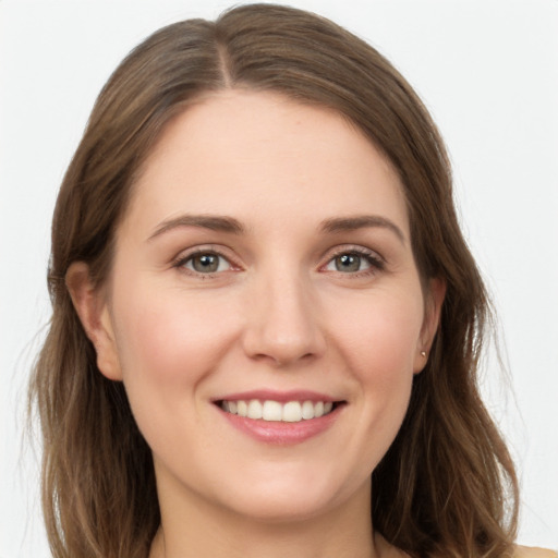 Joyful white young-adult female with long  brown hair and grey eyes